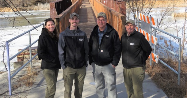 Courtesy/Pictured in front of the recently improved hike-bike trail bridge at Fort Kearny State Recreation Area are, from left, South-central Regional Park Superintendent Laura Rose, Fort Kearny State Historical Park/SRA Assistant Park Superintendent Elijah Lovin, Facilities Construction Coordinator Paul Mara, and Fort Kearny SHP/SRA Park Superintendent Gene Hunt. (Lori Potter photo)