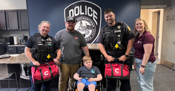Members of the Hastings Police and Kelley Family pose with their new Carter Kits. Photo Courtesy:Hastings Police Department